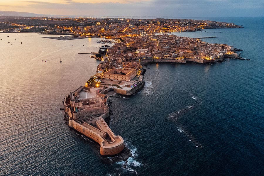 Aerial view of Ortigia Island and Siracusa city at sunset. Landmark in Sicily, Italy.